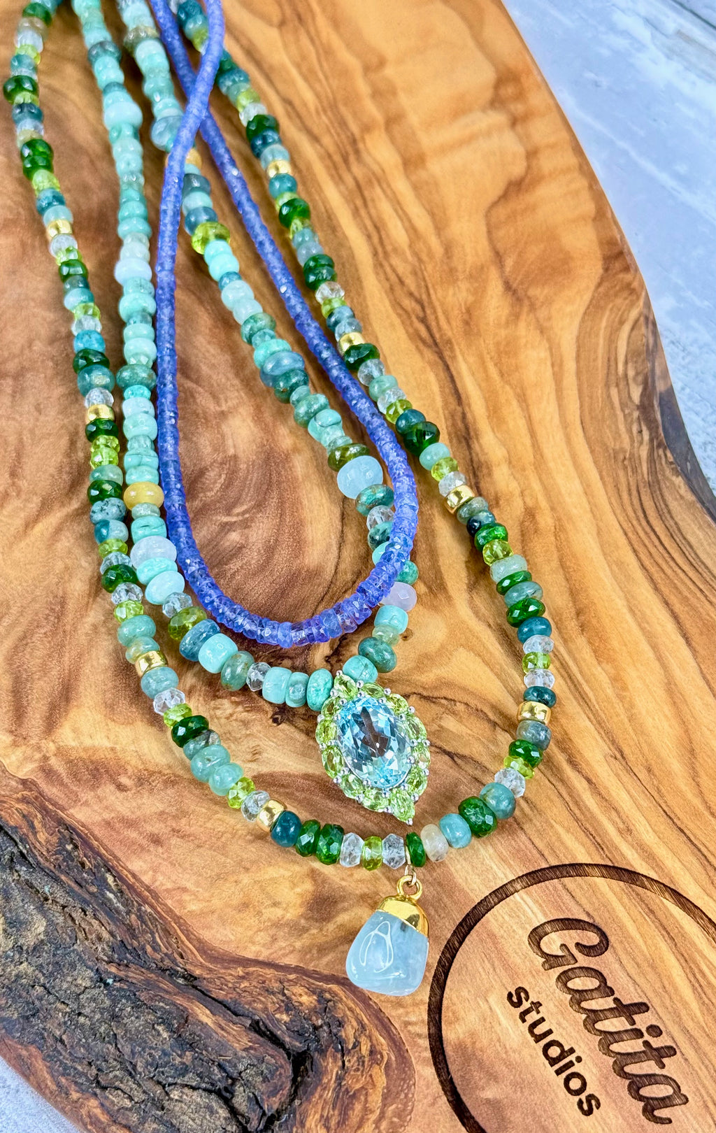 Multi-gemstone necklace with aquamarine pendant.