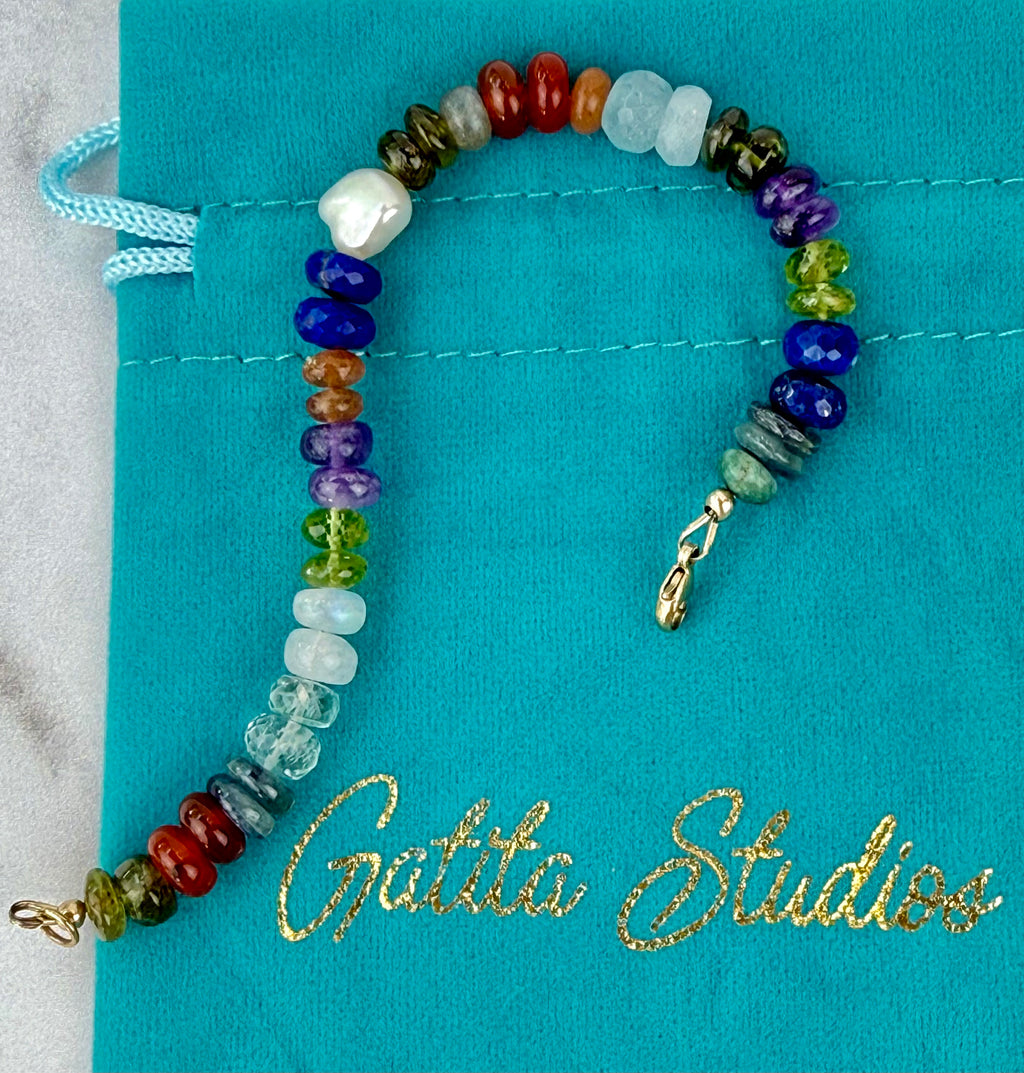 Multi gemstone bracelet with centered pearl