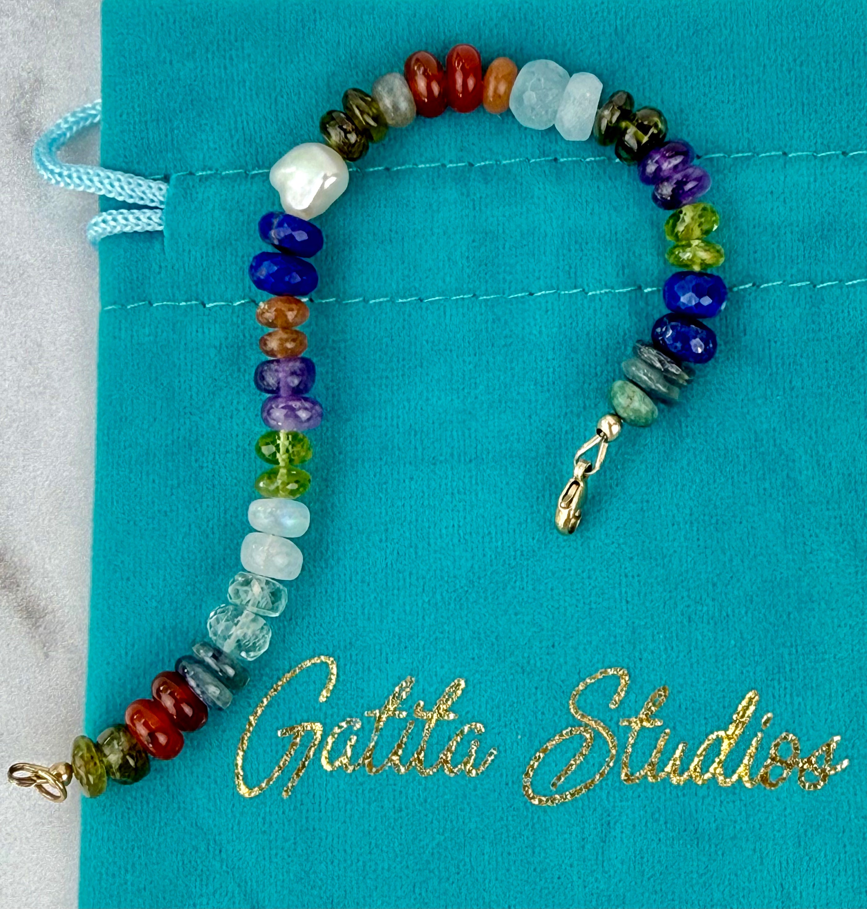 Multi gemstone bracelet with centered pearl
