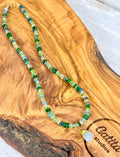 Multi-gemstone necklace with aquamarine pendant.